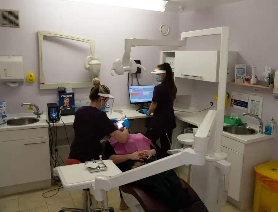 A dental therapist treating a patient